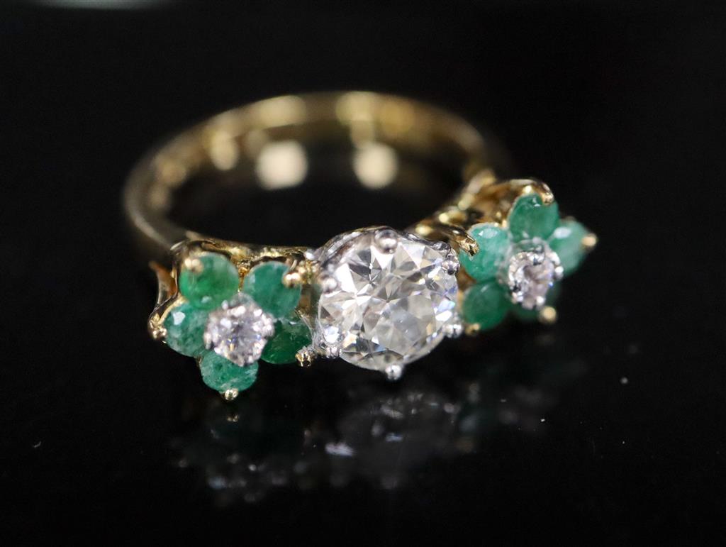 A modern 18k emerald and diamond set dress ring,